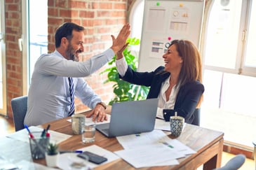 Manager high five with team member